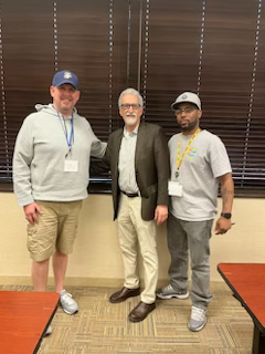 APWU President Mark Dimondstein is flanked by Steven Simms on the left and Jerry Bennet on the right